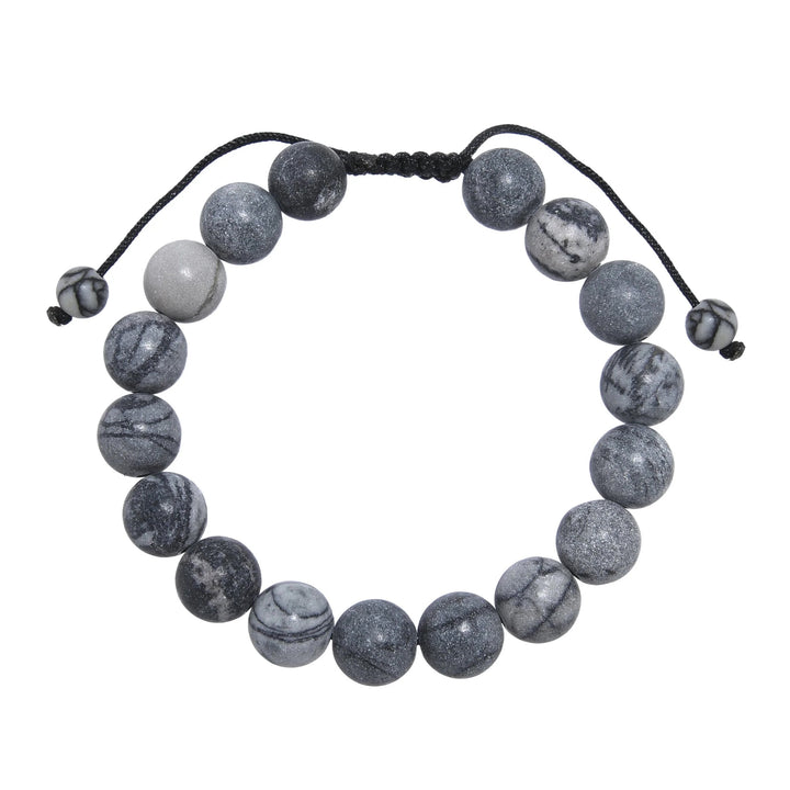 A close-up view of a black and gray network agate  bracelet, with 10mm round polished matte beads, and an adjustable pull-tie closure, on a white background.