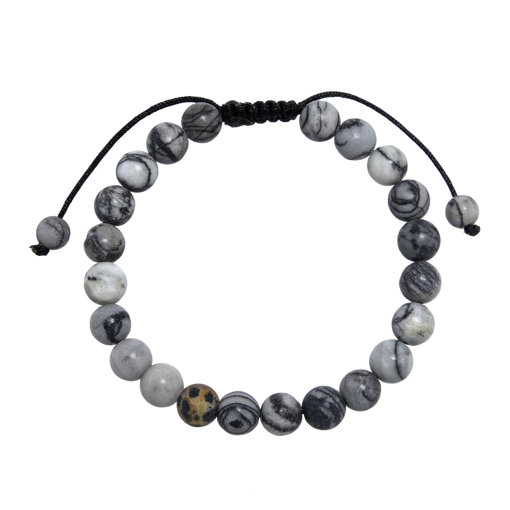 A close-up view of a black and gray network agate  bracelet, with 8mm round polished matte beads, and an adjustable pull-tie closure, on a white background.