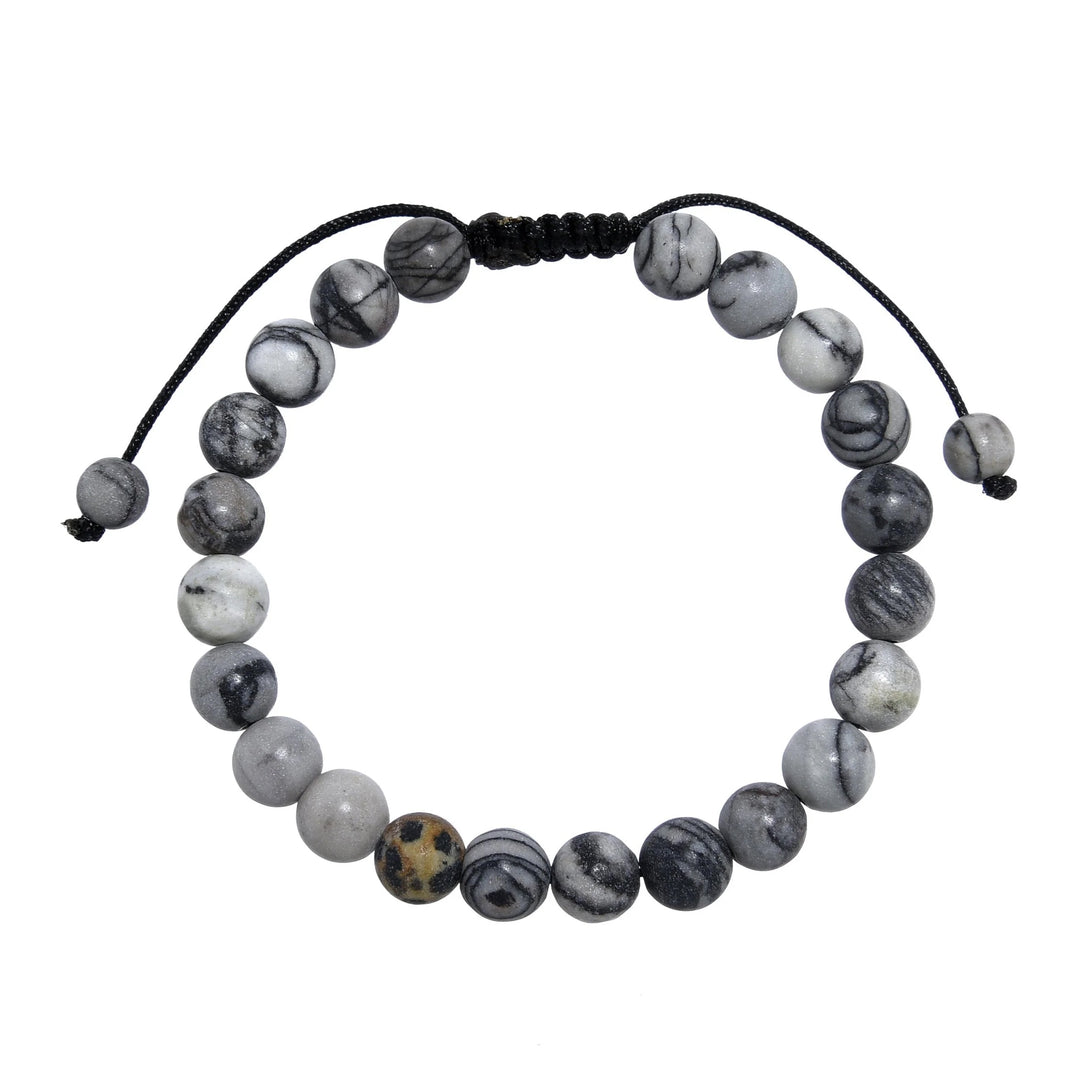 A close-up view of a black and gray network agate  bracelet, with 8mm round polished matte beads, and an adjustable pull-tie closure, on a white background.