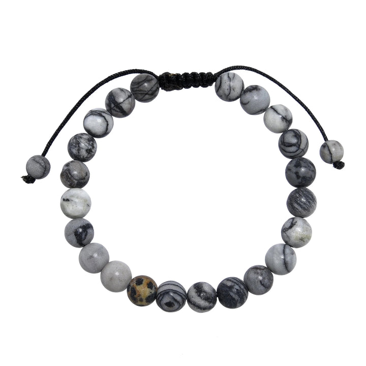 A close-up view of a black and gray network agate  bracelet, with 8mm round polished matte beads, and an adjustable pull-tie closure, on a white background.