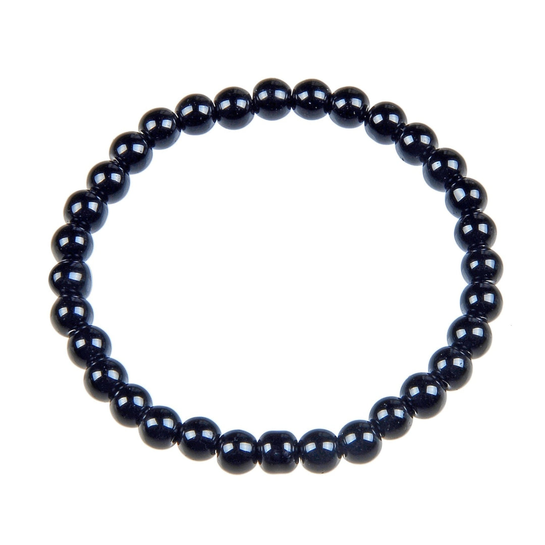 Close-up of a streth style bracelet made with 6mm  polished round black beads, displayed on a white background.