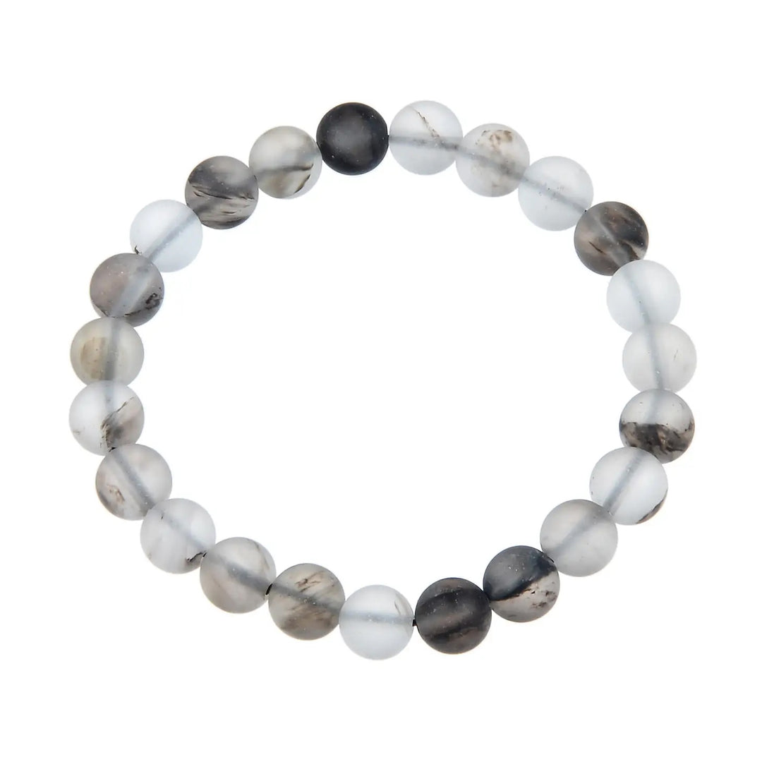 Close-up of a bracelet made with black watermelon stone 8mm beads in shades of white, gray, tan, and black, on a stretch cord, displayed against a white background.