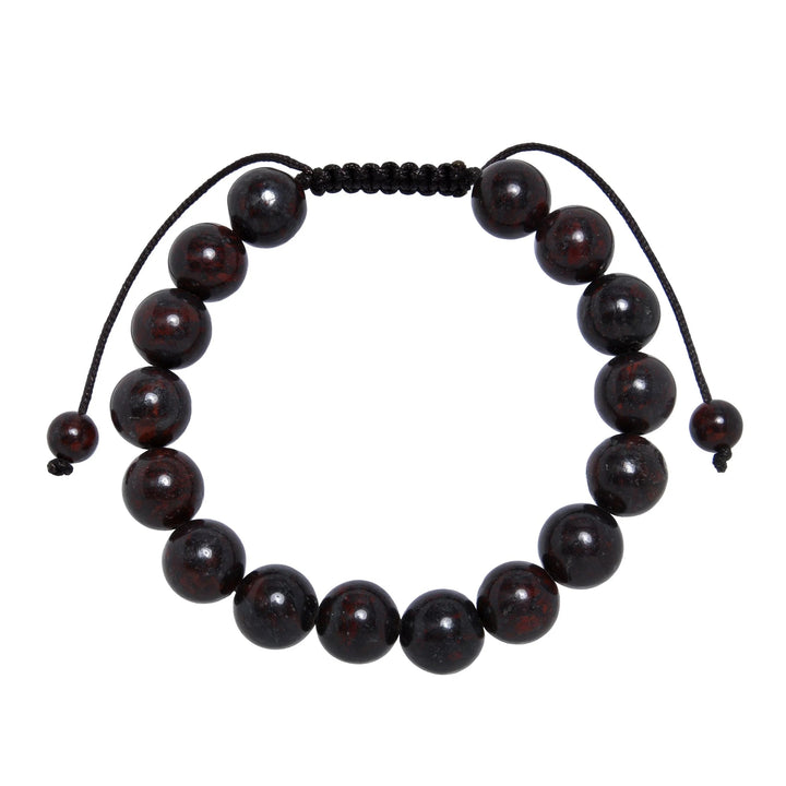 Close-up of a brecciated jasper bracelet made with 10mm round red brown beads and a dark brown pull tie style cord closure, displayed on a white background.