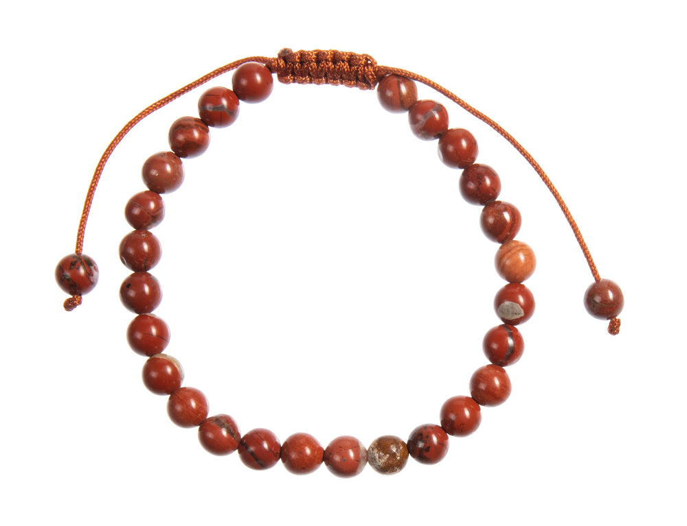 A close-up view of a carnelian bracelet, with 6mm round polished reddish orange with specks of black beads, and a reddish orange adjustable pull-tie closure, on a white background.