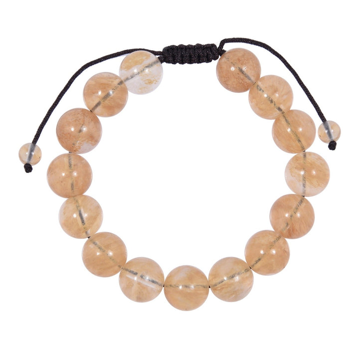 Close-up of a pale yellow citrine bracelet made with 12mm round beads and a dark brown black pull tie style cord closure, displayed on a white background.