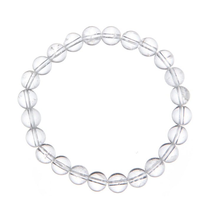 A close-up of a stretch bracelet made with 6mm round clear quartz beads connected with a clear stretch cord, on a white background.