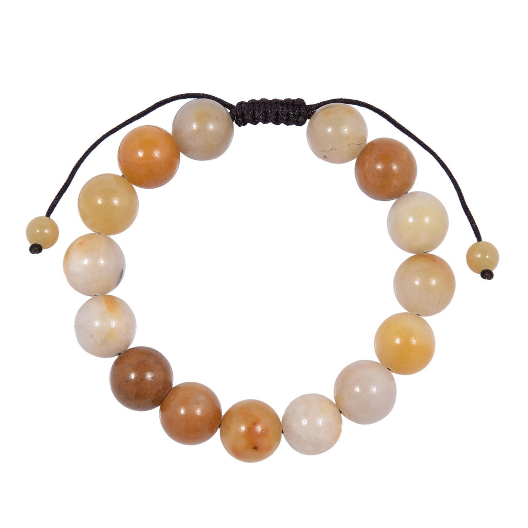 Close-up of a golden jade bracelet made with 12mm round beads with shades of pale to dark yellow and a dark brown pull tie style cord closure, displayed on a white background.