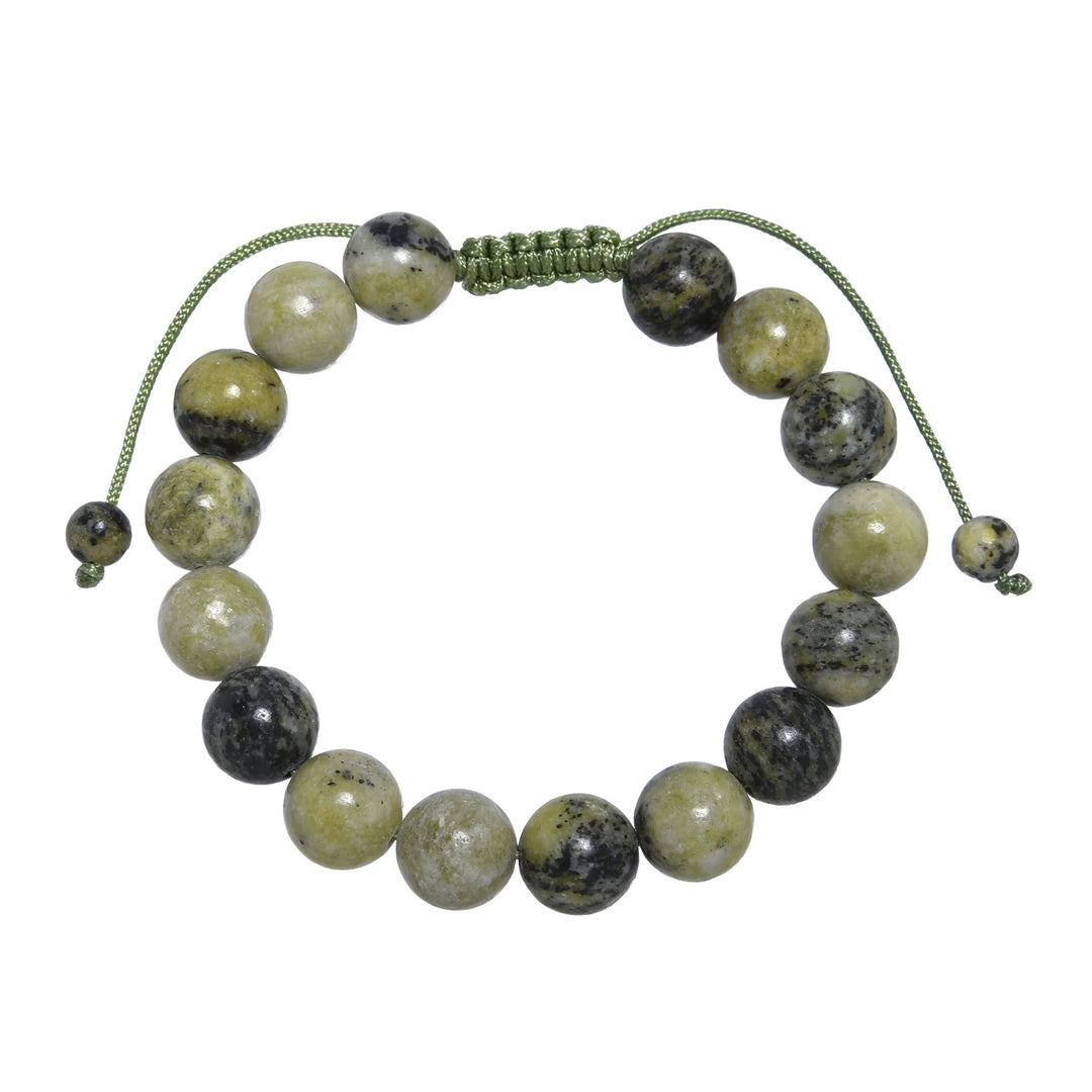Close-up of a grass yellow turquoise bracelet made with 10mm round polished beads with shades of green yellow, and black with a green pull tie style cord closure, displayed on a white background.