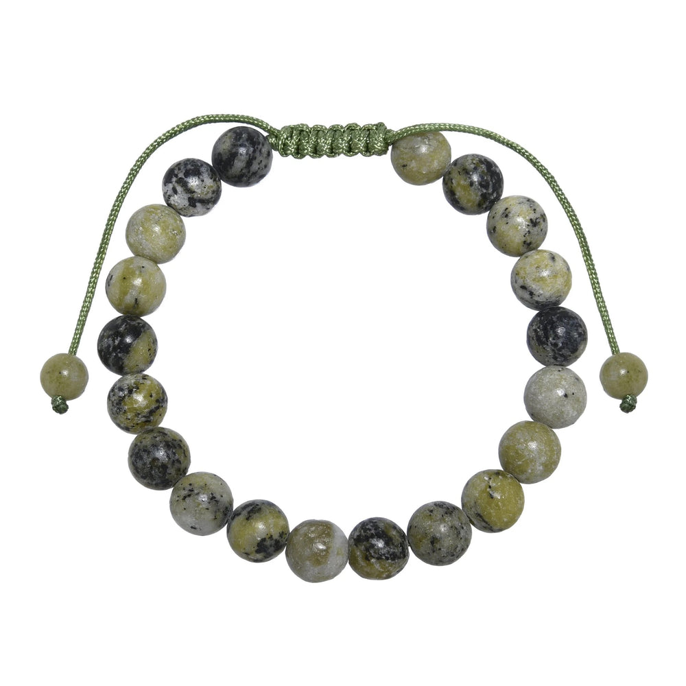 Close-up of a grass yellow turquoise bracelet made with 8mm round polished beads with shades of green yellow, and black with a green pull tie style cord closure, displayed on a white background.
