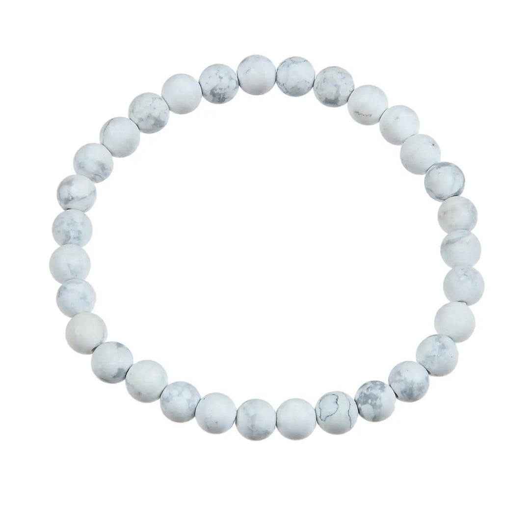 A bracelet made with 6mm round howlite stone beads, stretch style, in white and gray colors, displayed on a white background.