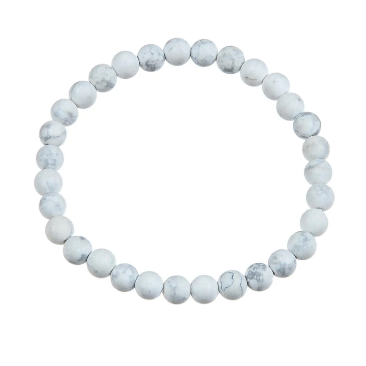 A bracelet made with 6mm round howlite stone beads, stretch style, in white and gray colors, displayed on a white background.