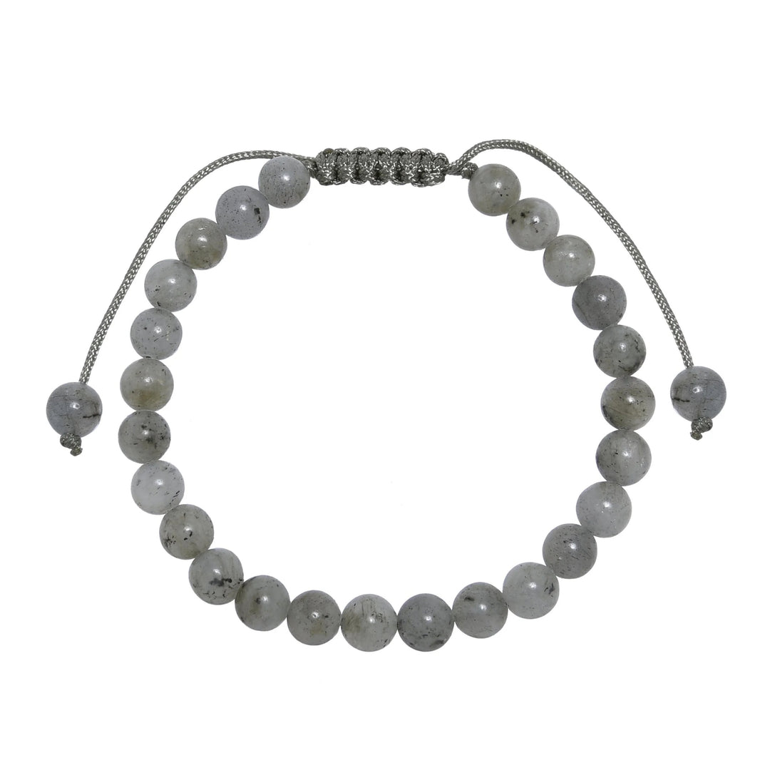 Close-up of a labradorite bracelet made with 6mm round polished gray beads and a gray pull tie style cord closure, displayed on a white background.