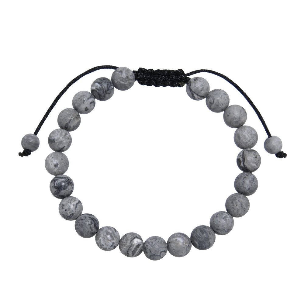 Close-up of a map stone jasper bracelet made with 8mm round beads with shades of gray, and a dark brown black pull tie style cord closure, displayed on a white background.