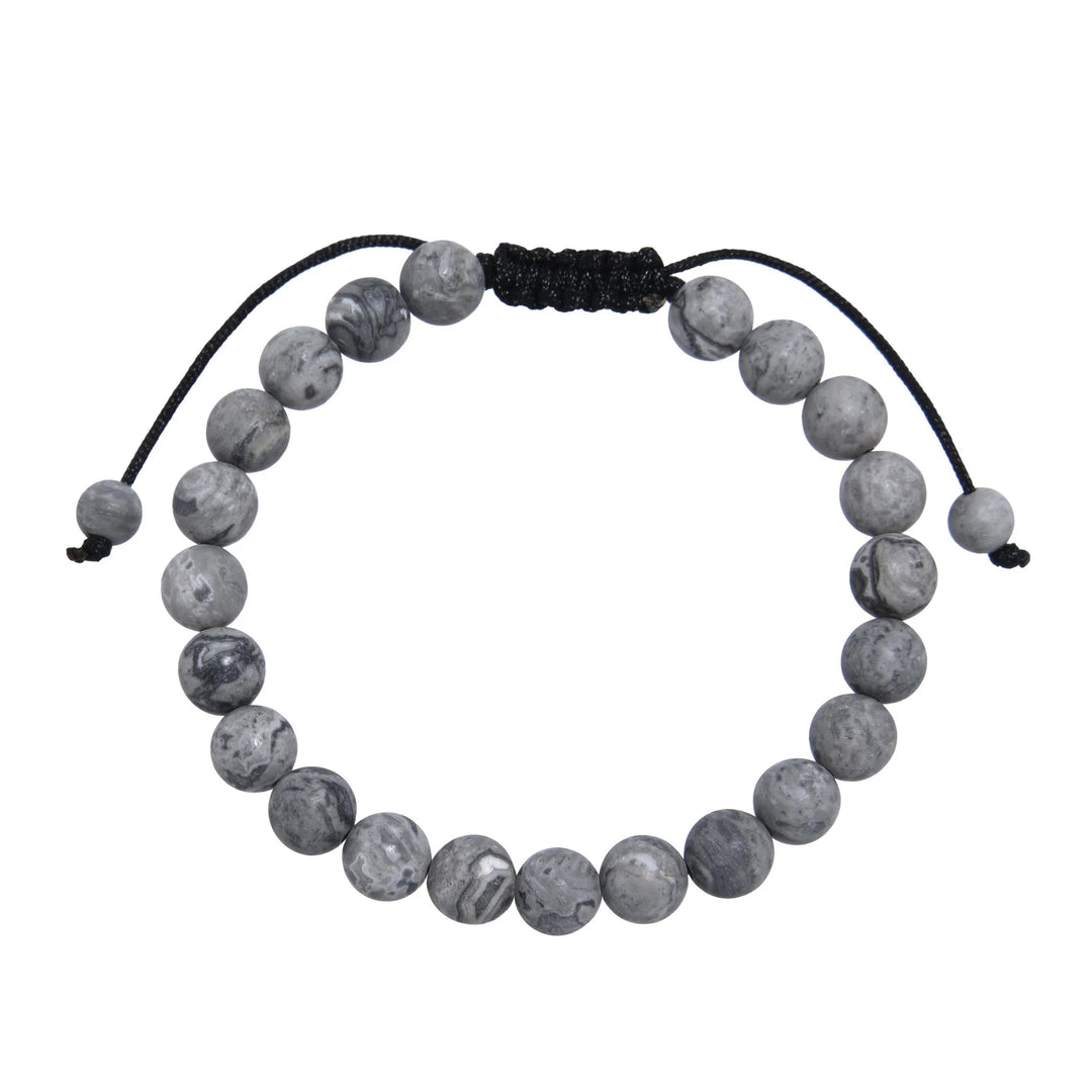 Close-up of a map stone jasper bracelet made with 8mm round beads with shades of gray, and a dark brown black pull tie style cord closure, displayed on a white background.
