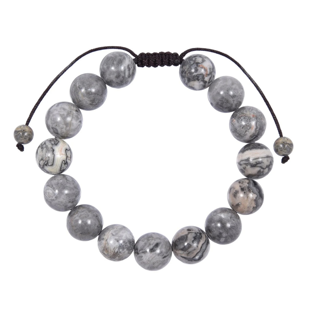 Close-up of a map stone jasper bracelet made with polished 12mm round beads with shades of gray and white colors, and a dark brown black pull tie style cord closure, displayed on a white background.