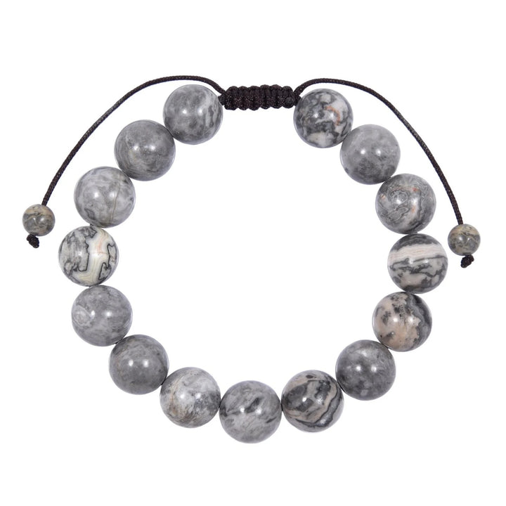 Close-up of a map stone jasper bracelet made with polished 12mm round beads with shades of gray and white colors, and a dark brown black pull tie style cord closure, displayed on a white background.