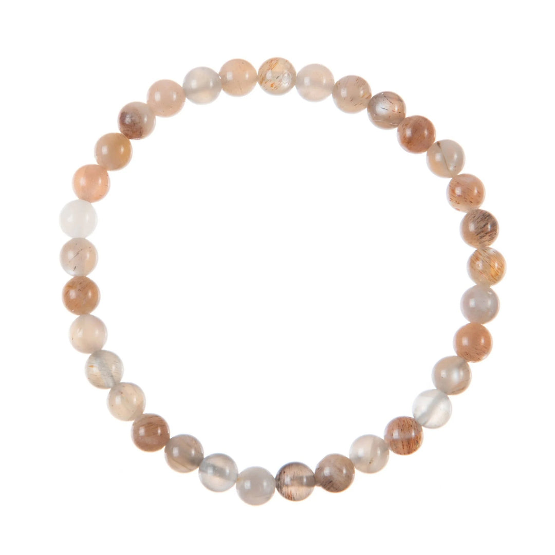 A close-up of a bracelet made with 6mm round mixed moonstone beads in shades of peach, white, and gray, connected with a clear stretch cord, on a white background.