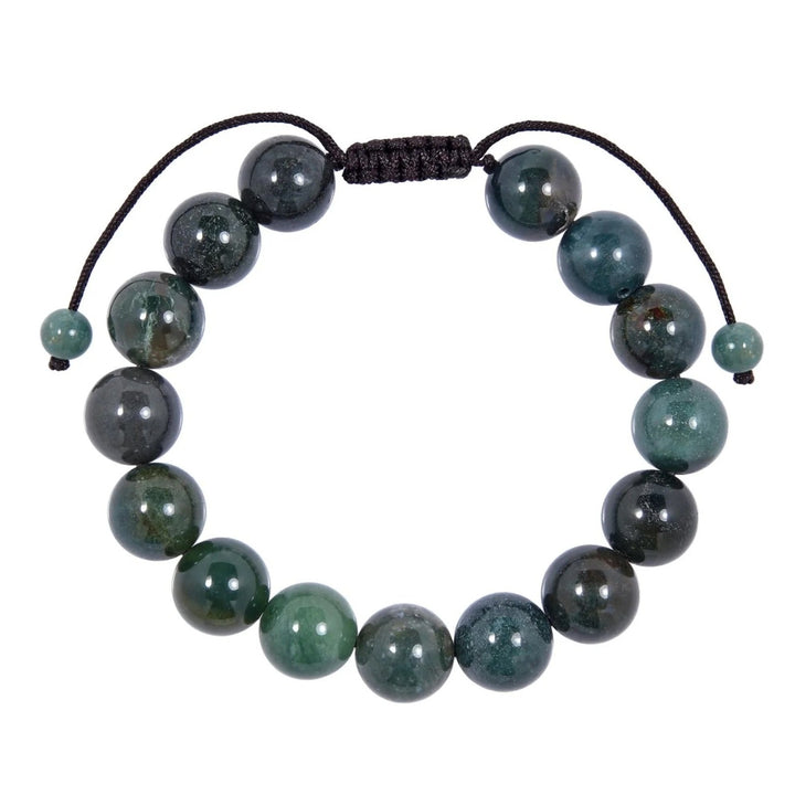 Close-up of a moss agate bracelet made with 12mm round beads with shades of green colors, and a dark brown pull tie style cord closure, displayed on a white background.