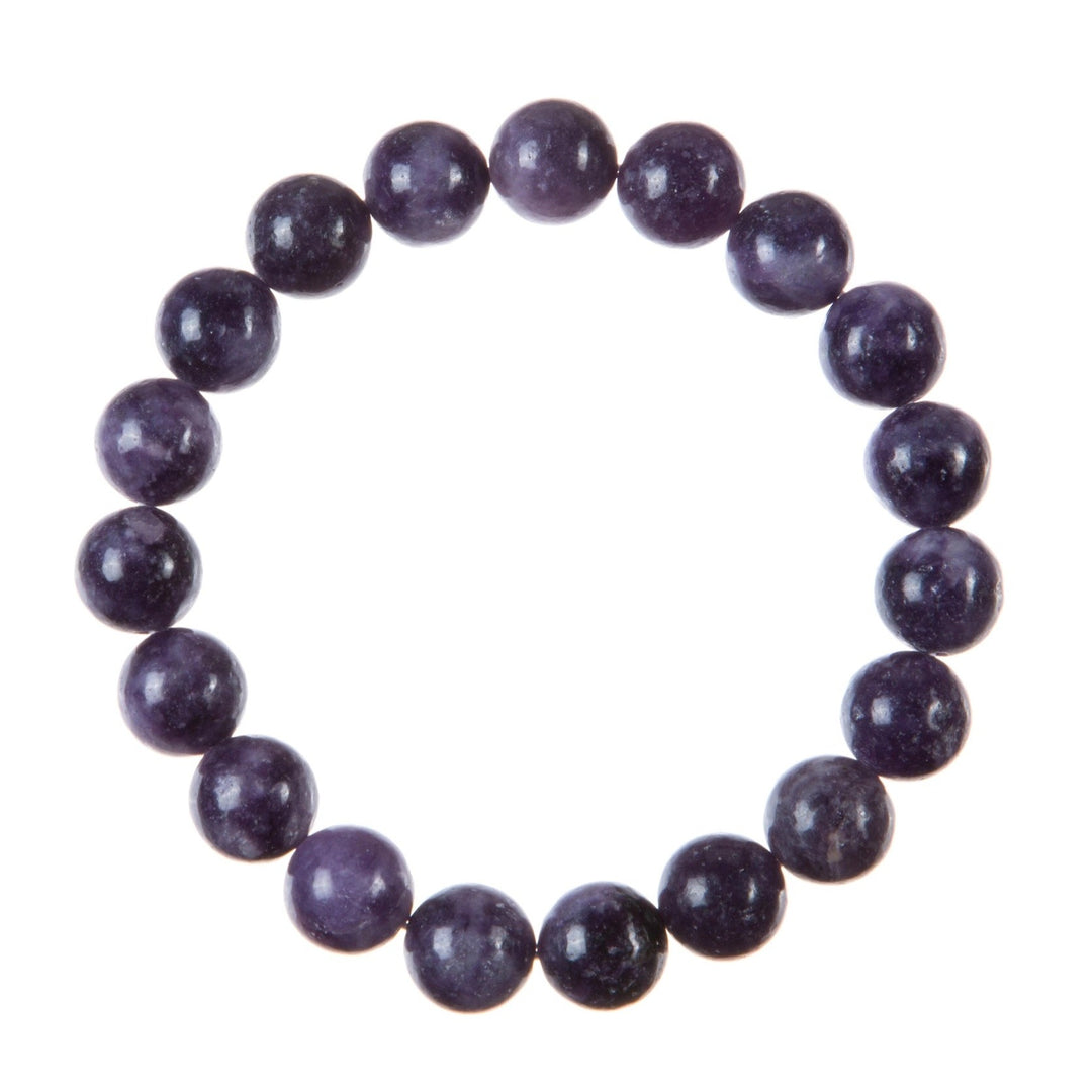 Close-up of a stretch style bracelet made with round 10mm polished purple phosohosiderite beads strung on a clear stretch cord and displayed on a white background.