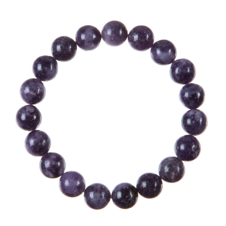Close-up of a stretch style bracelet made with round 10mm polished purple phosohosiderite beads strung on a clear stretch cord and displayed on a white background.
