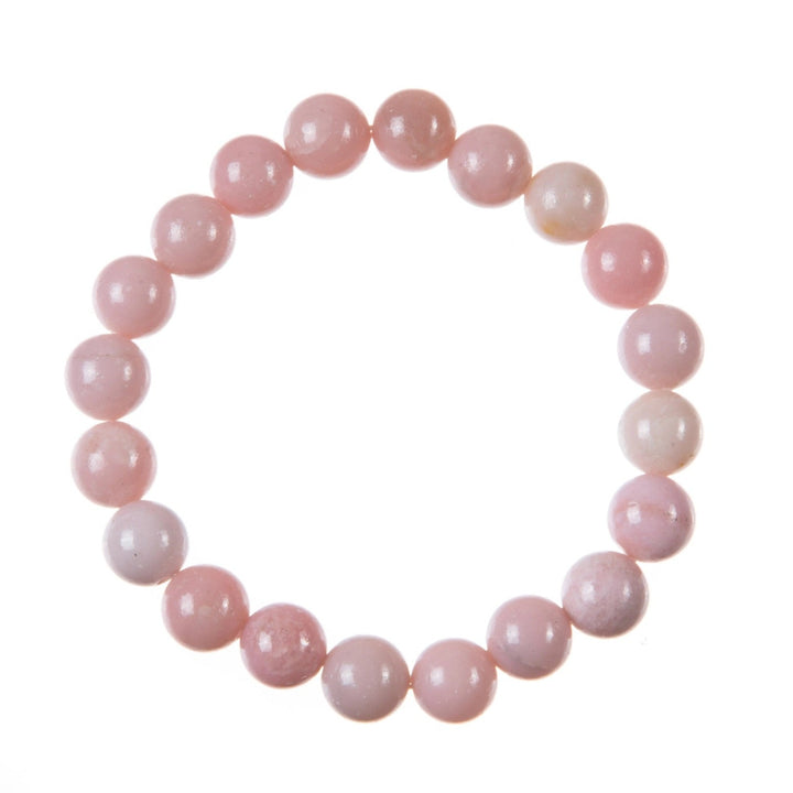 Close-up of a bracelet made with pink opal stone 10mm beads on a stretch cord, displayed against a white background.