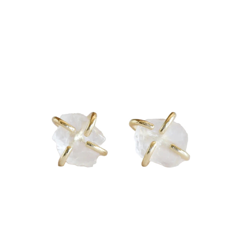 Pair of stud type earrings with gold prongs and white clear quartz center stone, on a white backgroud.