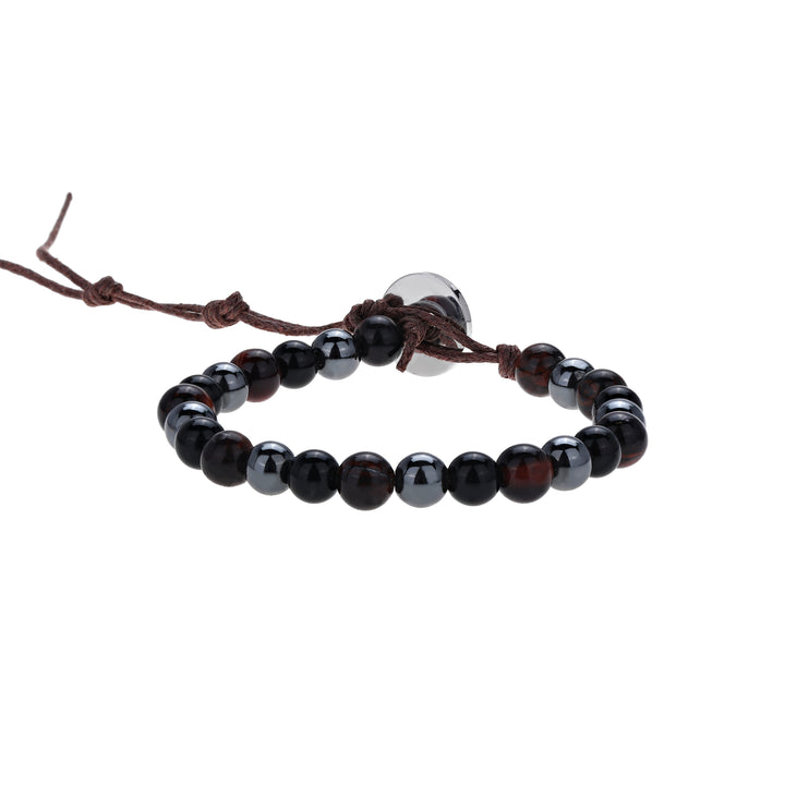 Close-up of a bead bracelet made with 6mm tiger's eye, black onyx, and hematite beads; in black, brown and dark gray colors, strung on an adjustable brown cord, with a silver color button closure displayed on a white background.