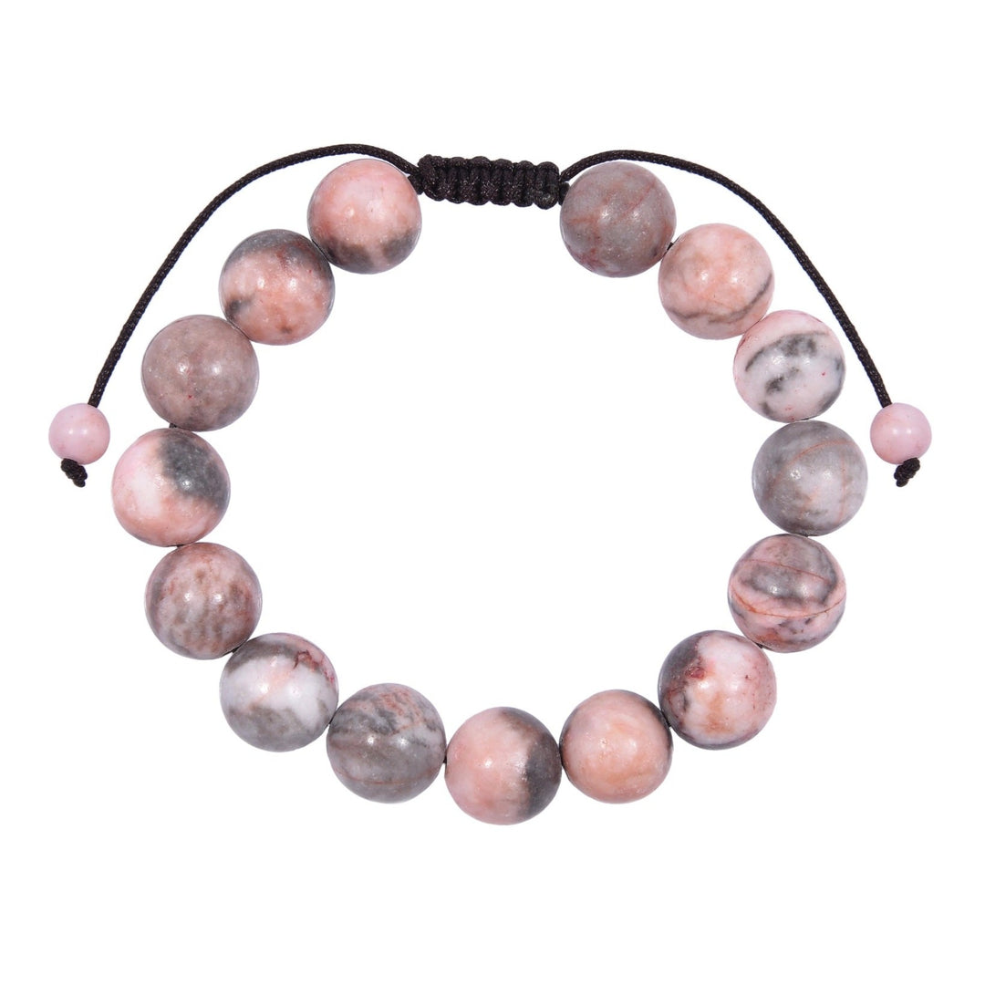 Close-up of a rhodonite bracelet made with polished 12mm round beads with shades of pink and gray, and a dark brown pull tie style cord closure, displayed on a white background.