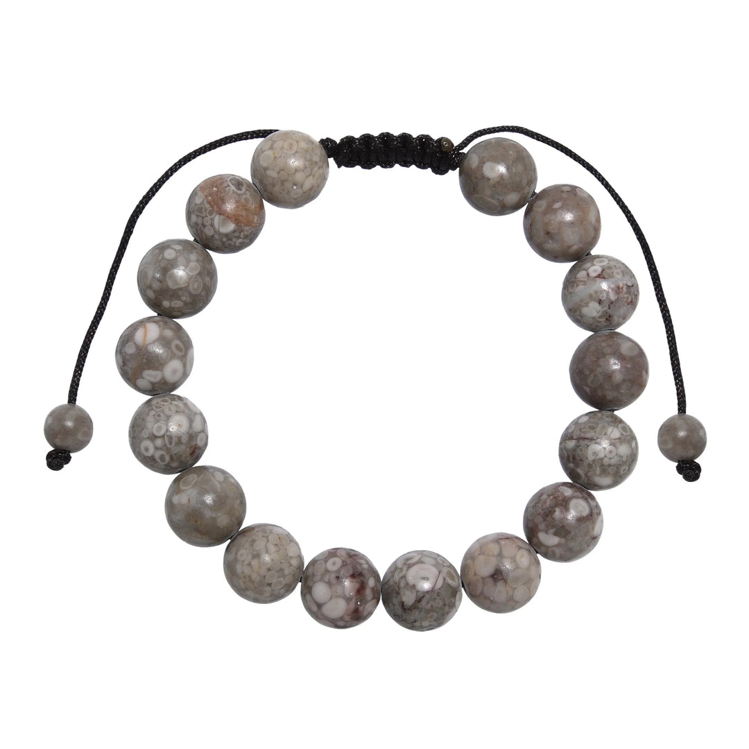 Close-up of a tree agate bracelet made with 10mm round beads with shades of gray and tan colors, and a dark brown black pull tie style cord closure, displayed on a white background.
