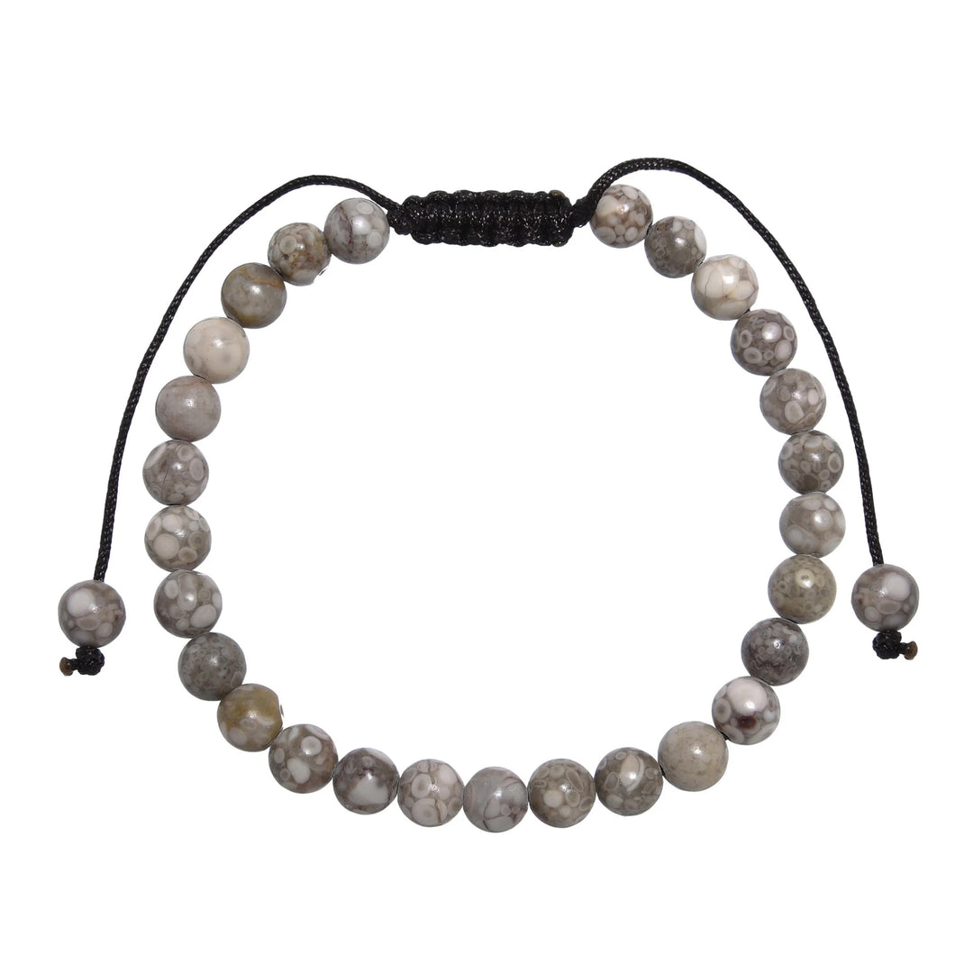 Close-up of a tree agate bracelet made with 6mm round beads with shades of gray and tan colors, and a dark brown black pull tie style cord closure, displayed on a white background.