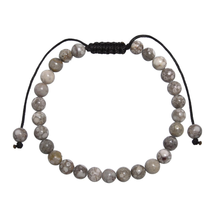 Close-up of a tree agate bracelet made with 6mm round beads with shades of gray and tan colors, and a dark brown black pull tie style cord closure, displayed on a white background.