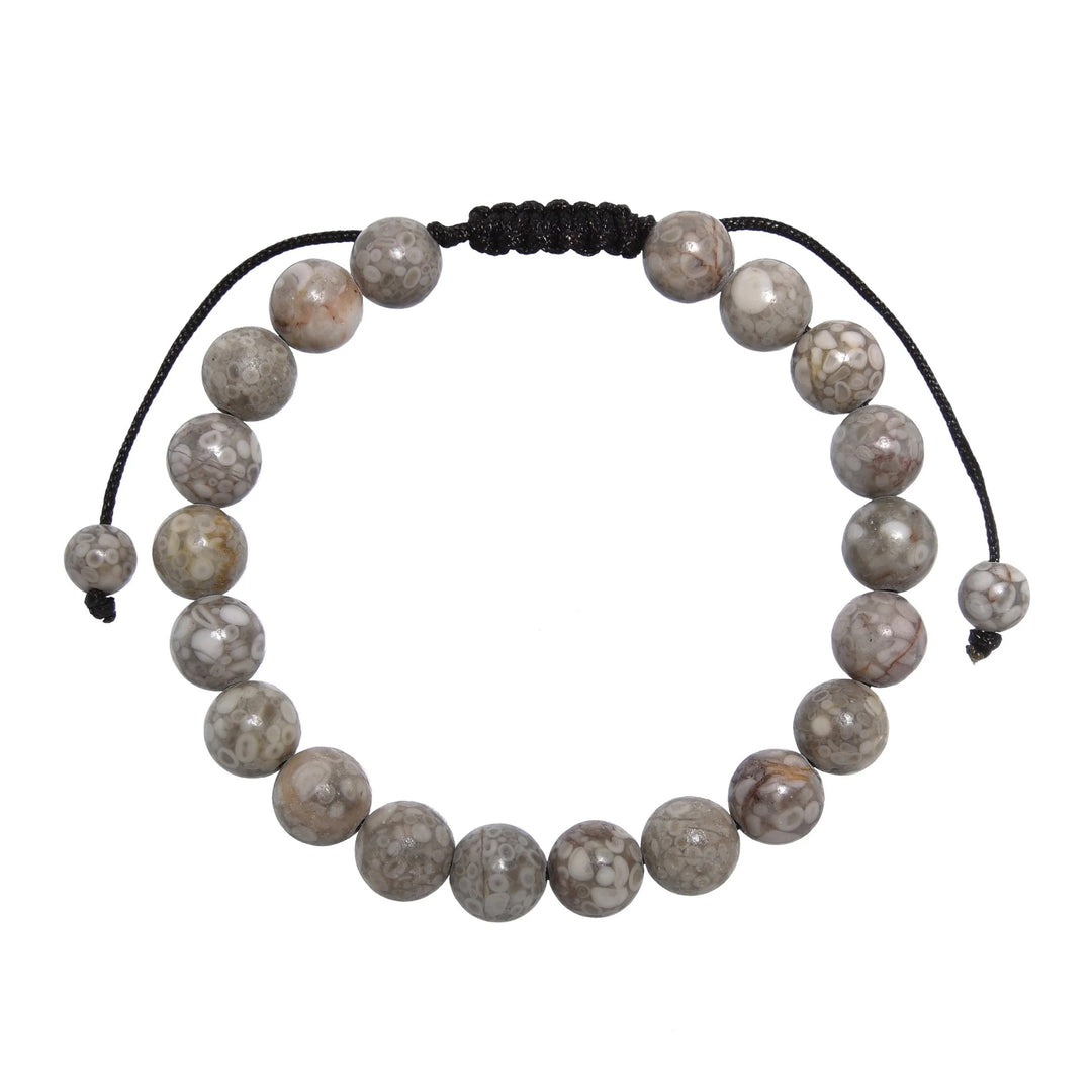 Close-up of a tree agate bracelet made with 8mm round beads with shades of gray and tan colors, and a dark brown black pull tie style cord closure, displayed on a white background.