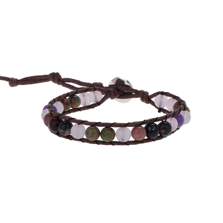 Close-up of a wrap style bead bracelet made with 6mm rose quartz, amethyst, and rhodonite, in shades of pink, green, black, purple and brown colors, strung on an adjustable brown cord, with a silver  button closure, displayed on a white background.