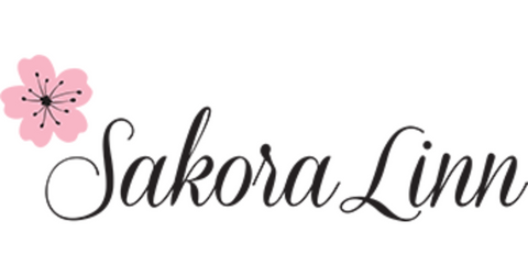Sakora Linn written in black script font and a pink cherry blossom, with black in the center of the blossom, all on a white background.
