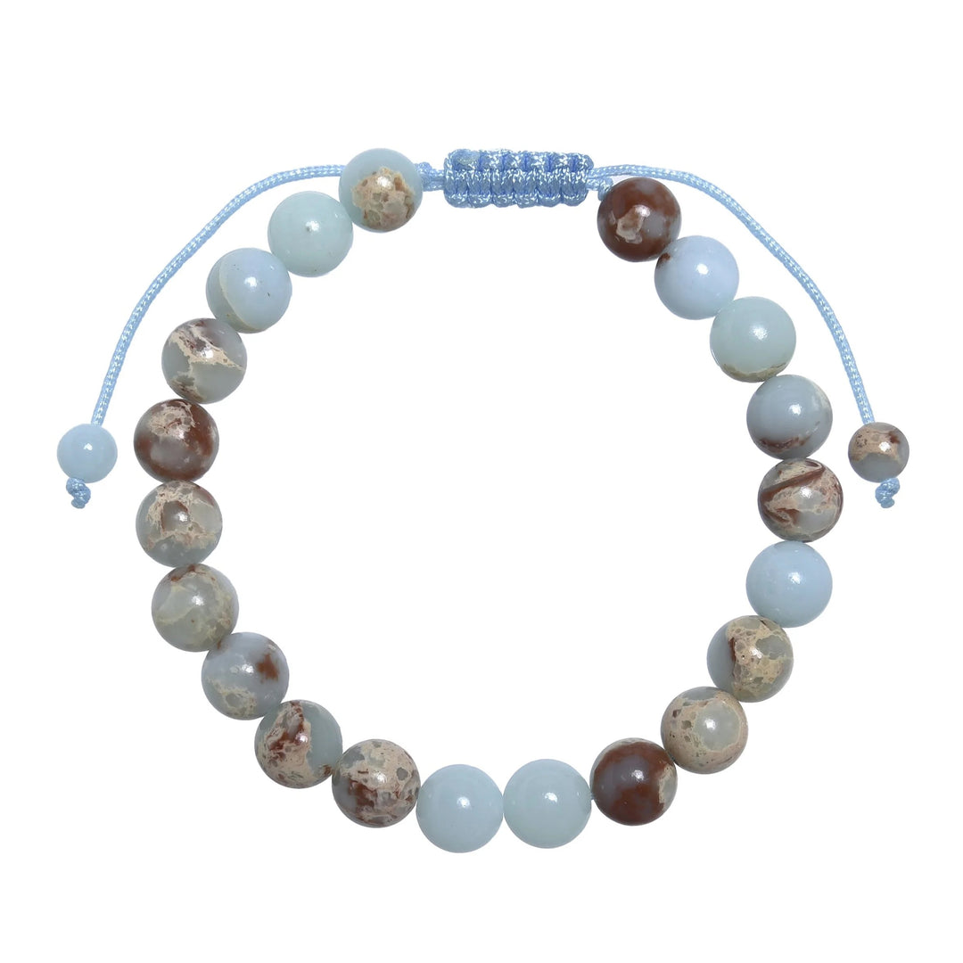 Close-up of a shoushan stone bracelet made with 8mm round polished beads with shades of light blue colors, tan, red, and cream, and a blue pull tie style cord closure, displayed on a white background.