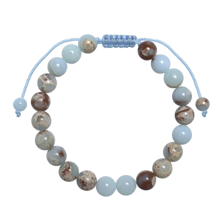 Close-up of a shoushan stone bracelet made with 8mm round polished beads with shades of light blue colors, tan, red, and cream, and a blue pull tie style cord closure, displayed on a white background.