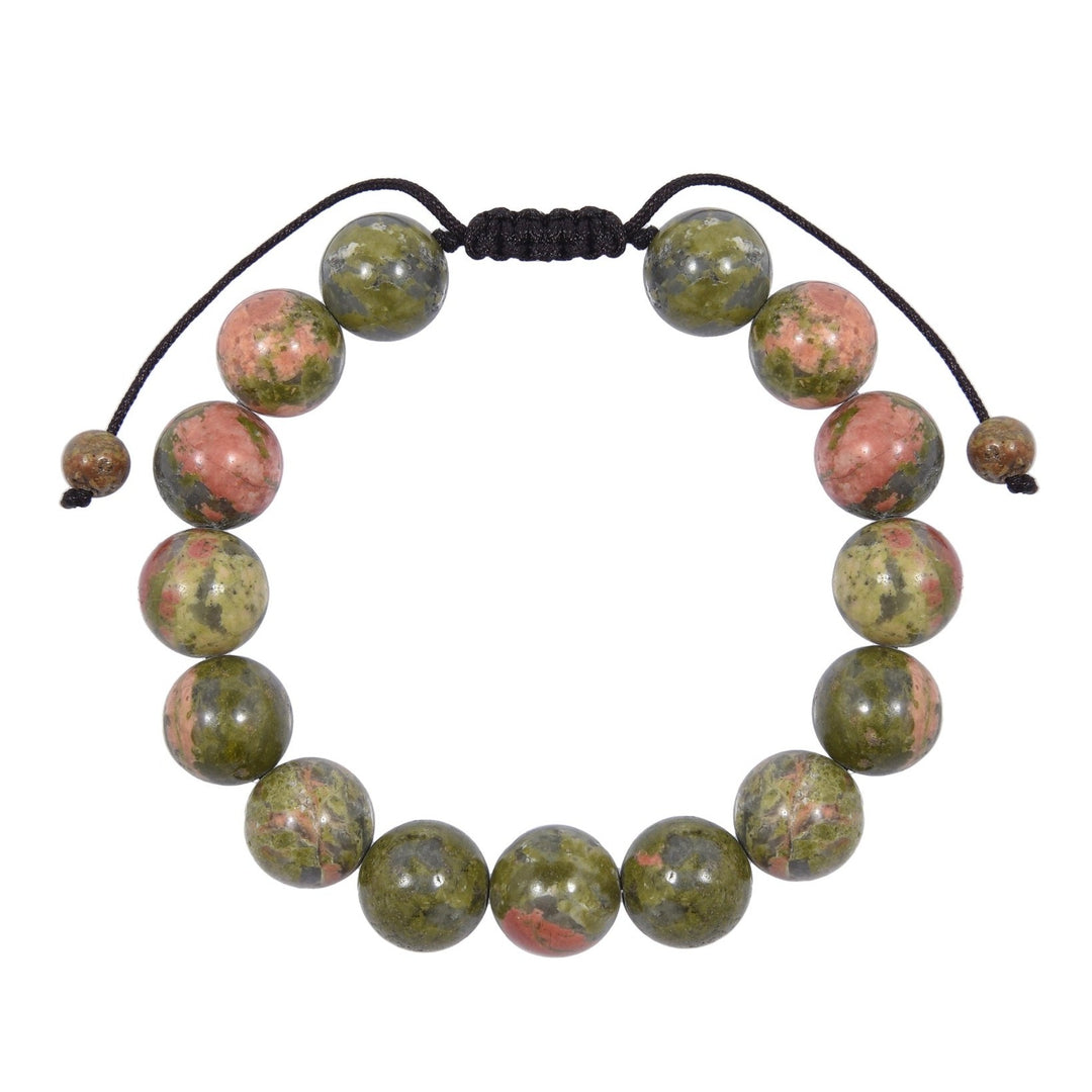 Close-up of a unakite bracelet made with 12mm round beads with shades of green and pink colors, and a dark brown pull tie style cord closure, displayed on a white background.