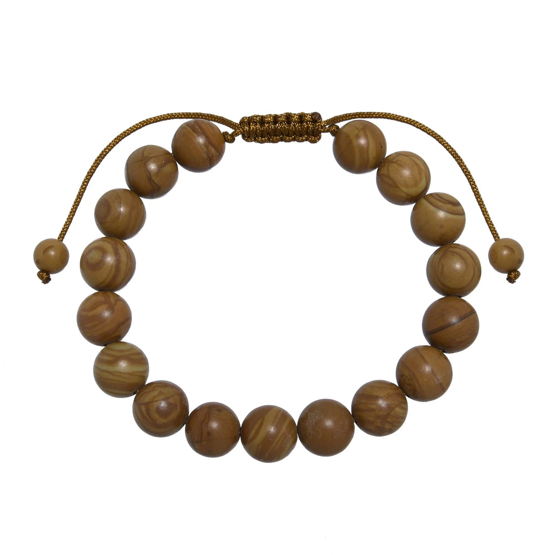 Close-up of a woodline jasper bracelet made with 10mm round polished brown  beads that look like wood, with a brown pull tie style cord closure, displayed on a white background.