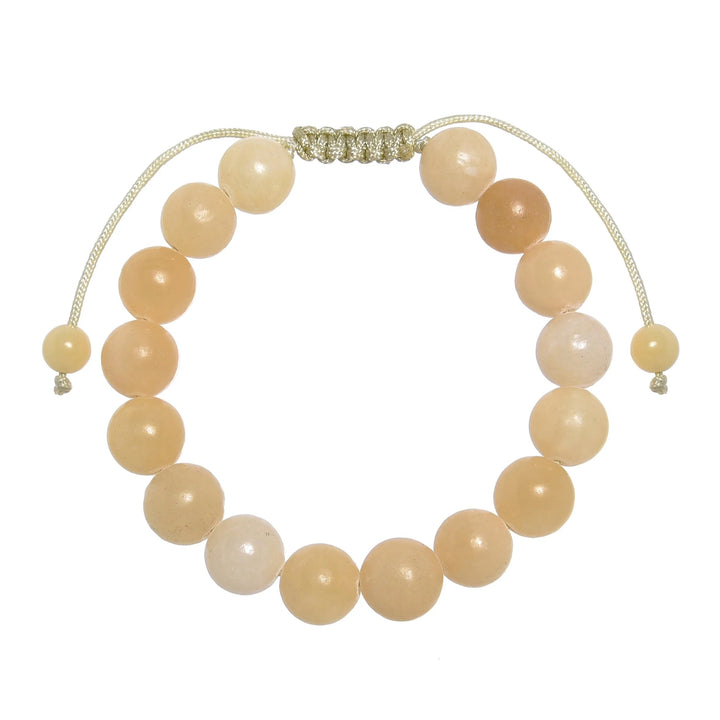 Close-up of a yellow jade bracelet made with 10mm round yellow jade beads, with a pastel yellow pull tie style cord closure, displayed on a white background.