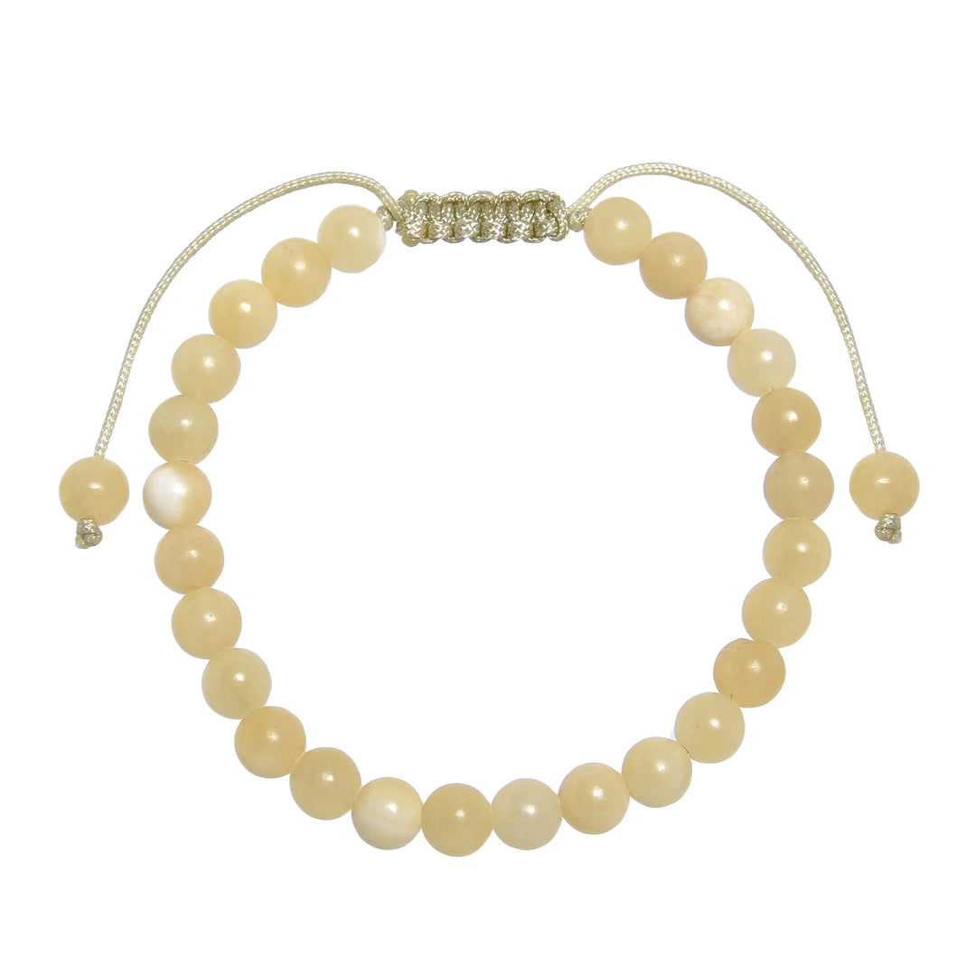 Close-up of a yellow jade bracelet made with 6mm round yellow jade beads, with a pastel yellow pull tie style cord closure, displayed on a white background.