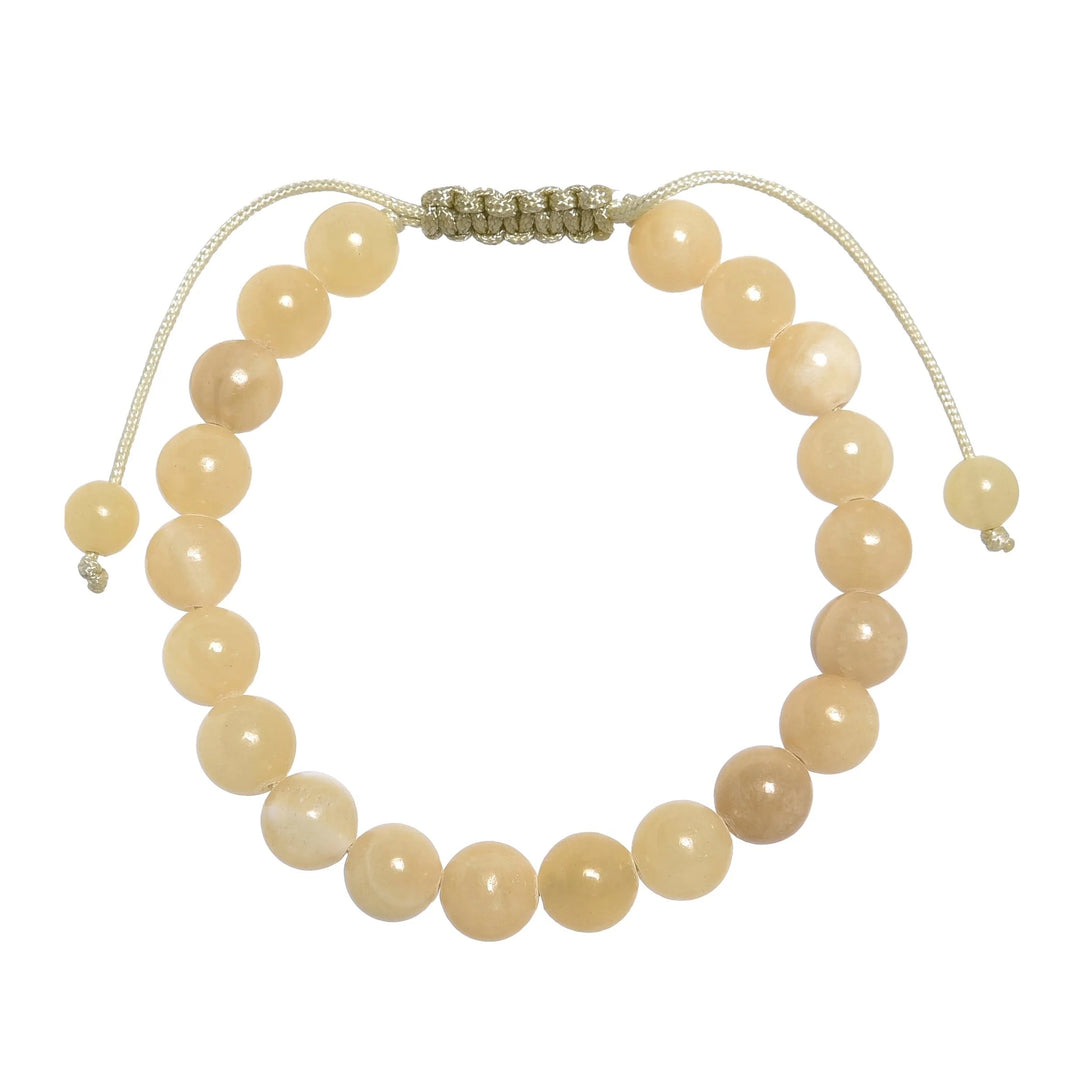 Close-up of a yellow jade bracelet made with 8mm round yellow jade beads, with a pastel yellow pull tie style cord closure, displayed on a white background.