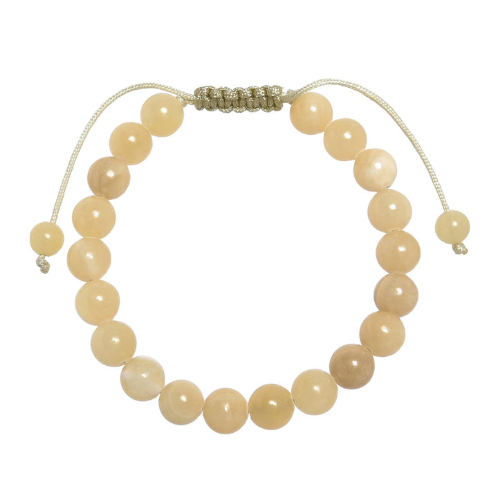 Close-up of a yellow jade bracelet made with 8mm round yellow jade beads, with a pastel yellow pull tie style cord closure, displayed on a white background.