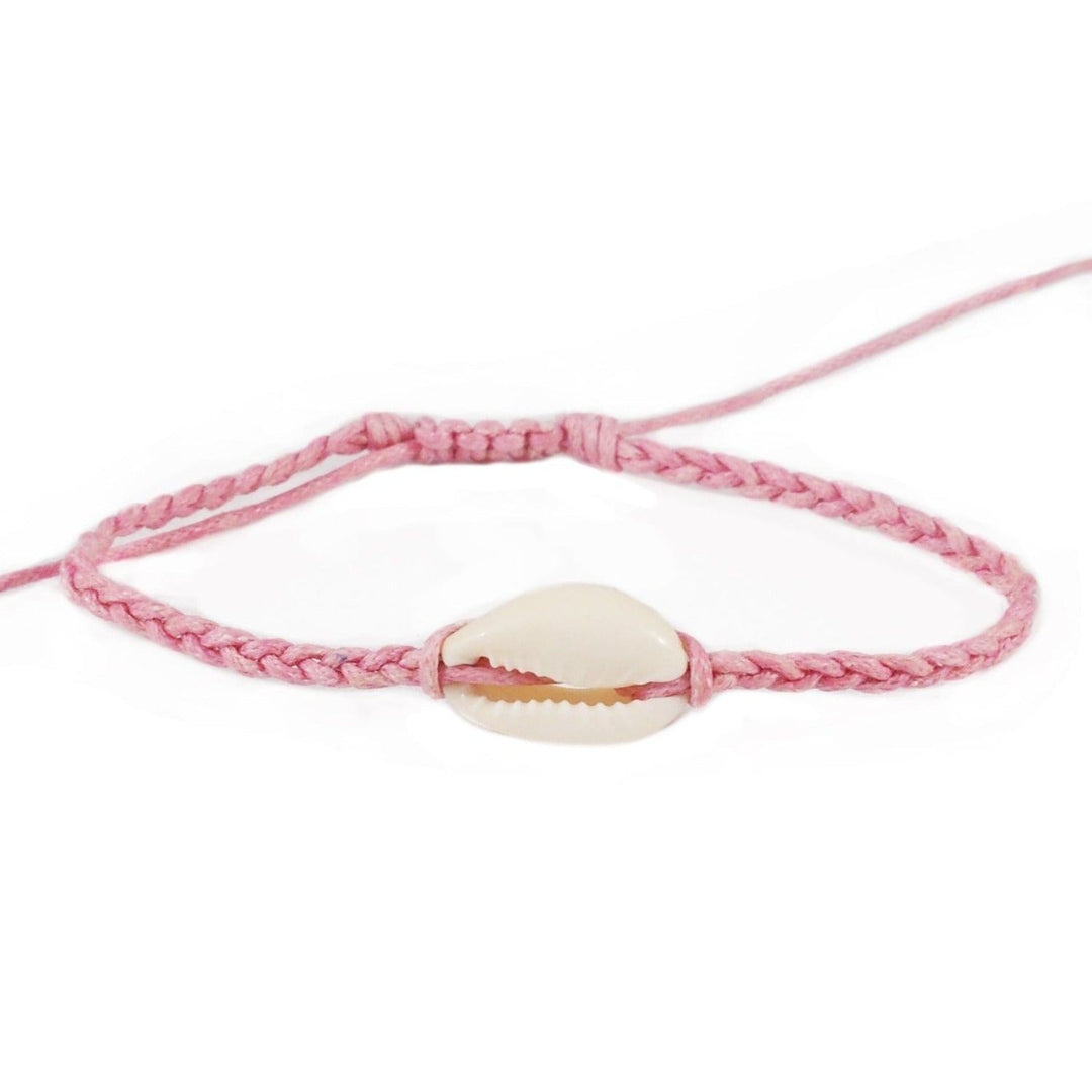 Close-up of a pink braided slip knot syle bracelet with a white cowry sea shell in the center, displayed on a white background.