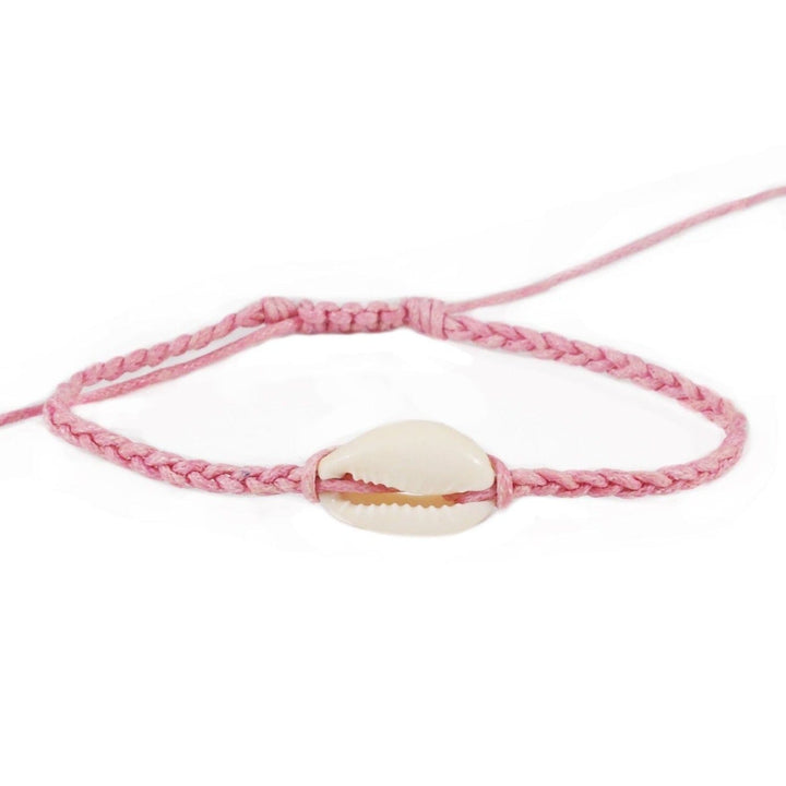 Close-up of a pink braided slip knot syle bracelet with a white cowry sea shell in the center, displayed on a white background.