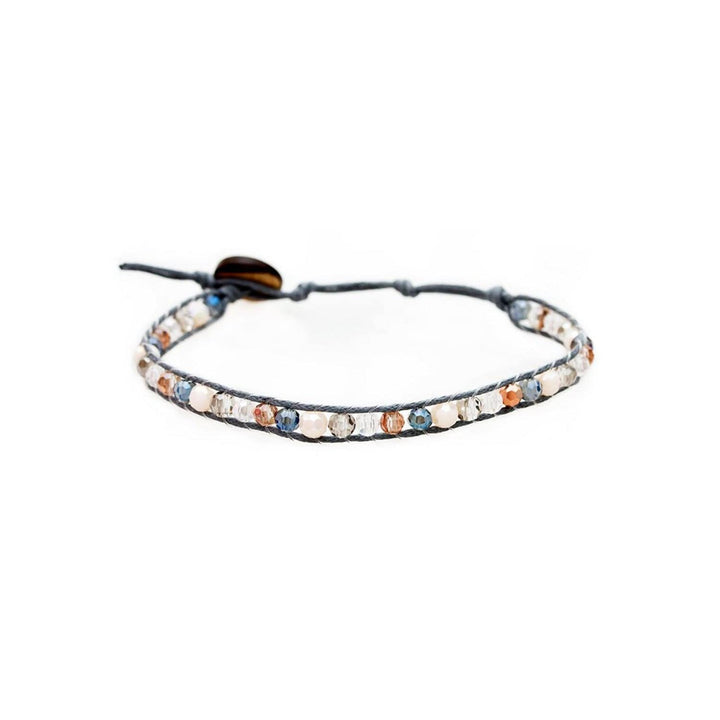 Close-up of a crystal wrap bracelet with 4mm blue, cream, gray, orange, clear beads, a gray adjustable cord with coconit button closure, displayed on a white background.