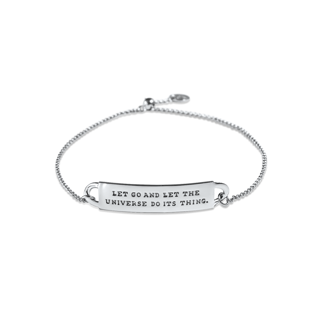 A silver-colored chain ID style bracelet with a  message band that reads 'LET GO AND LET THE UNIVERSE DO ITS THING.'