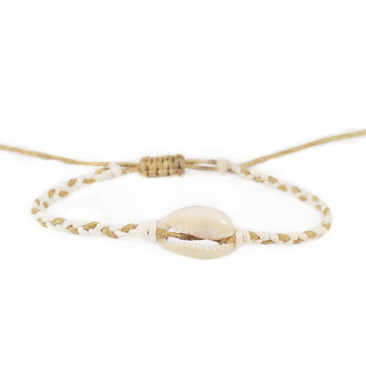 Close-up of a natural tan rope color and white braided slip knot syle bracelet with a white cowry sea shell in the center, displayed on a white background.