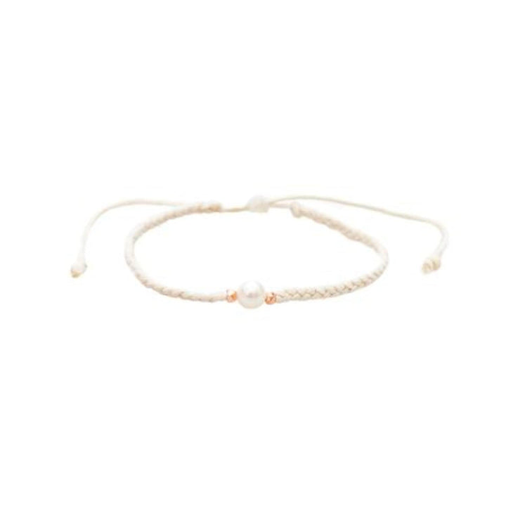 Close-up of a white braided slip knot syle bracelet with a white fresh water pearl in the center and small gold accent beads on each side of the pearl, displayed on a white background.