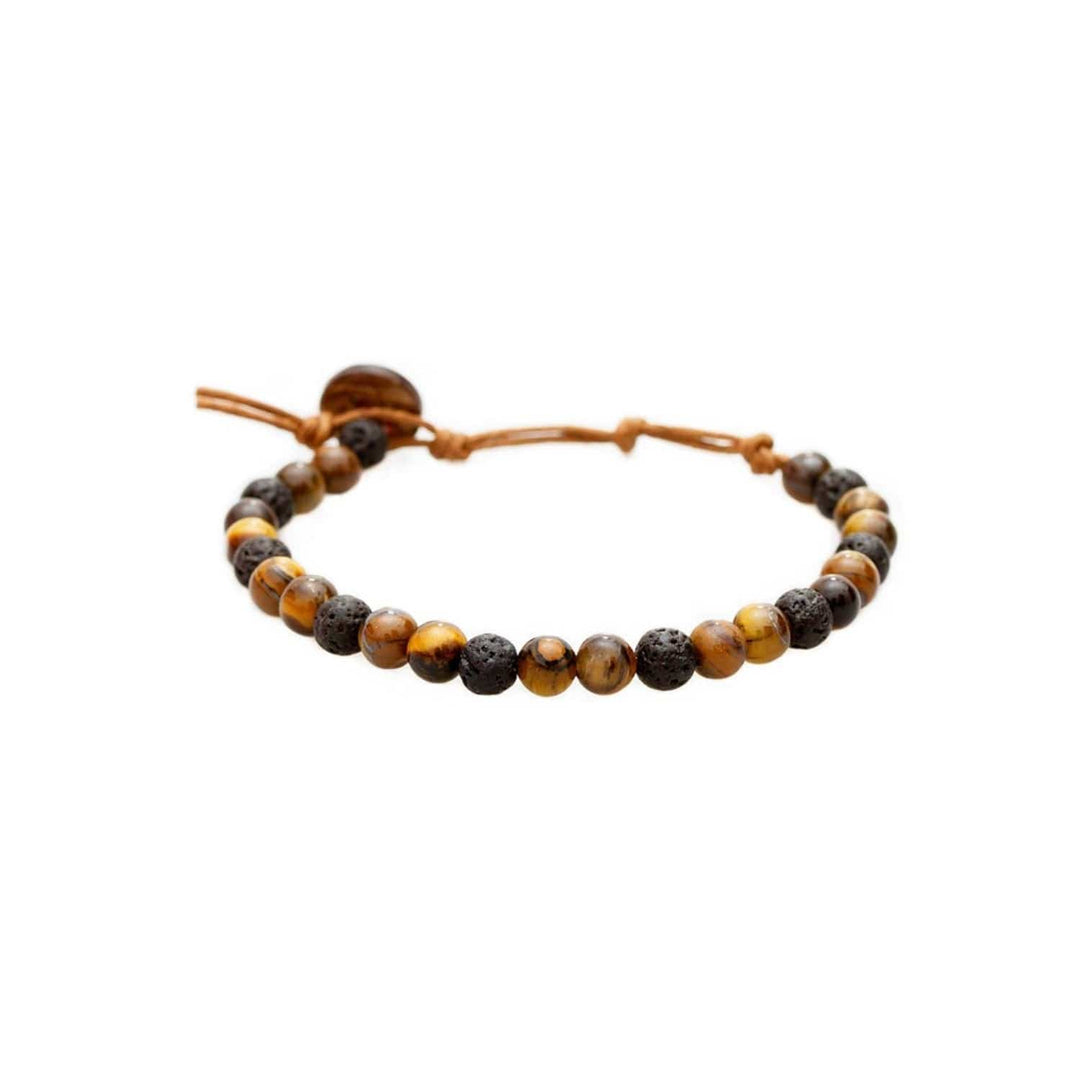 Close-up of a healing bead bracelet with round 6mm tiger's eye and lava stone  beads in shades of brown and black colors, with a adjustable brown cord and dark brown coconut shell button closure, displayed on a white background.